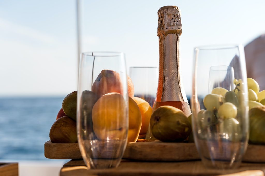 Fruit tray and bottle of champagne for romantic date on a yacht