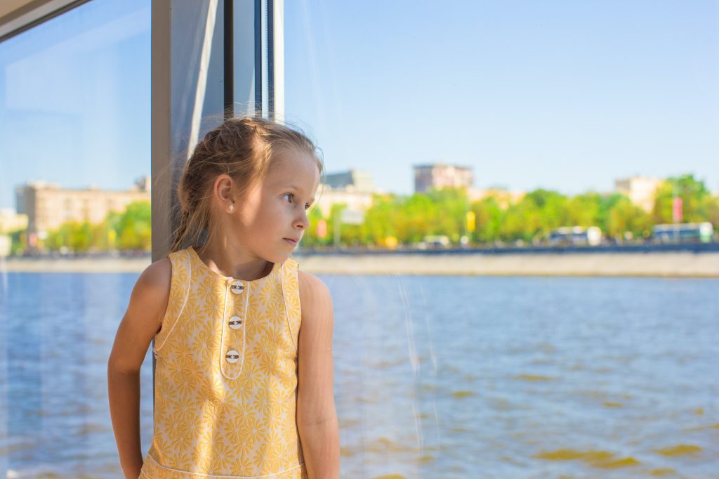 Little adorable girl relaxing on a luxury ship