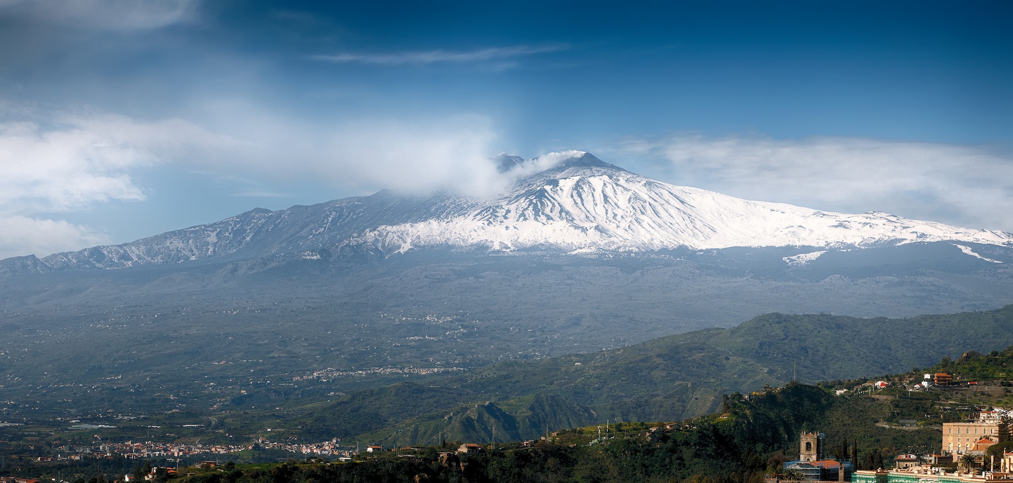 Smoking Mount Etna Volcano as seen from Taormina