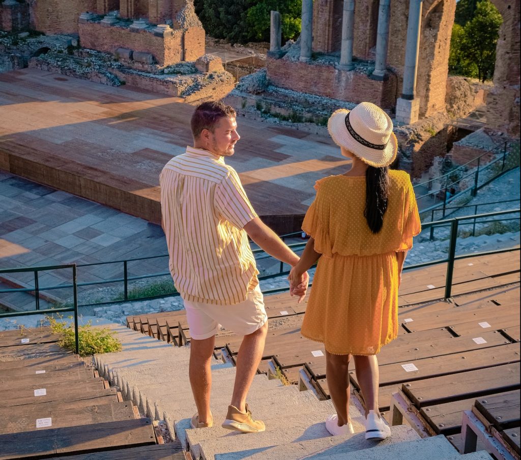 Taormina Sicily, couple watching sunset at the Ruins of the Ancient Greek Theater